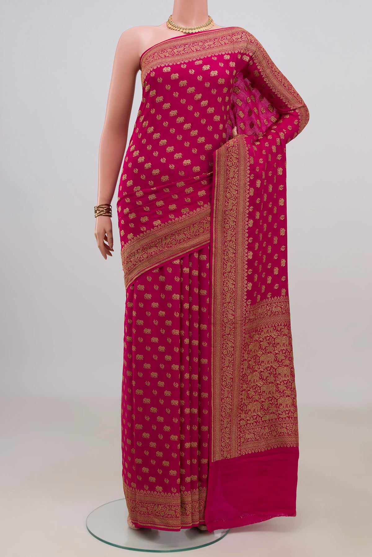 Pink Banarasi Georgette Saree with Zari Butta on the body and Fancy Border.  displayed on a mannequin