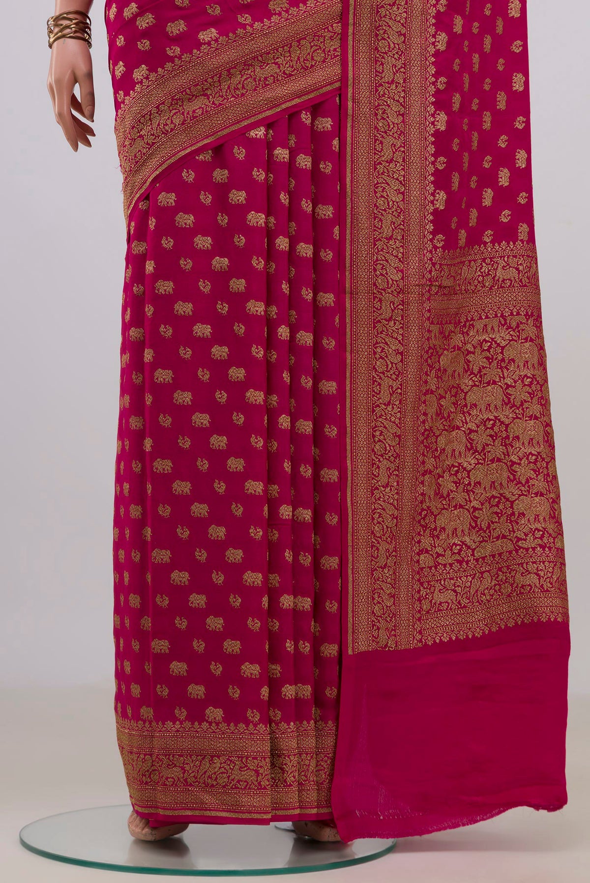 Pleats and pallu of Pink Banarasi Georgette Saree with Zari Butta on the body and Fancy Border. 