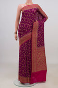 Magenta Banarasi Georgette Saree with Zari Brocade on the body and Zari Border.  displayed on a mannequin
