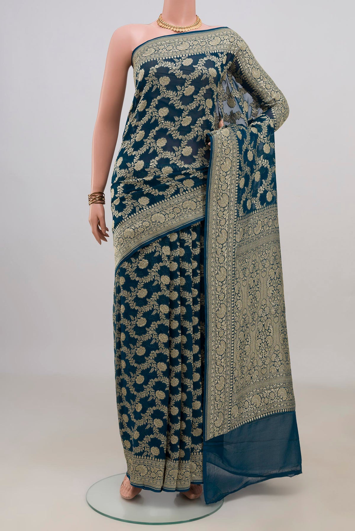 Blue Georgette Saree with Fancy on the body and Fancy Border.  displayed on a mannequin
