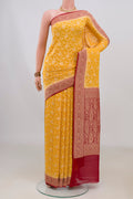 Yellow Banarasi Georgette Saree with Zari Brocade on the body and Fancy Border.  displayed on a mannequin