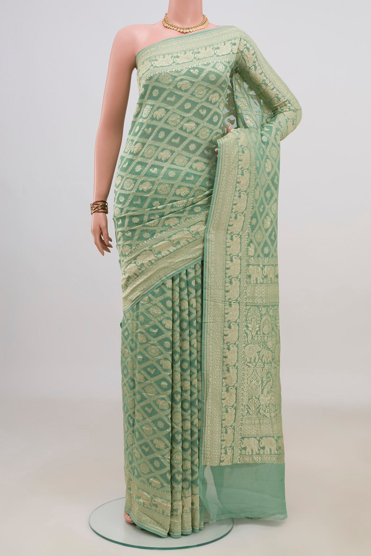 Pista Green Banarasi Georgette Saree with Zari Brocade on the body and Fancy Border.  displayed on a mannequin