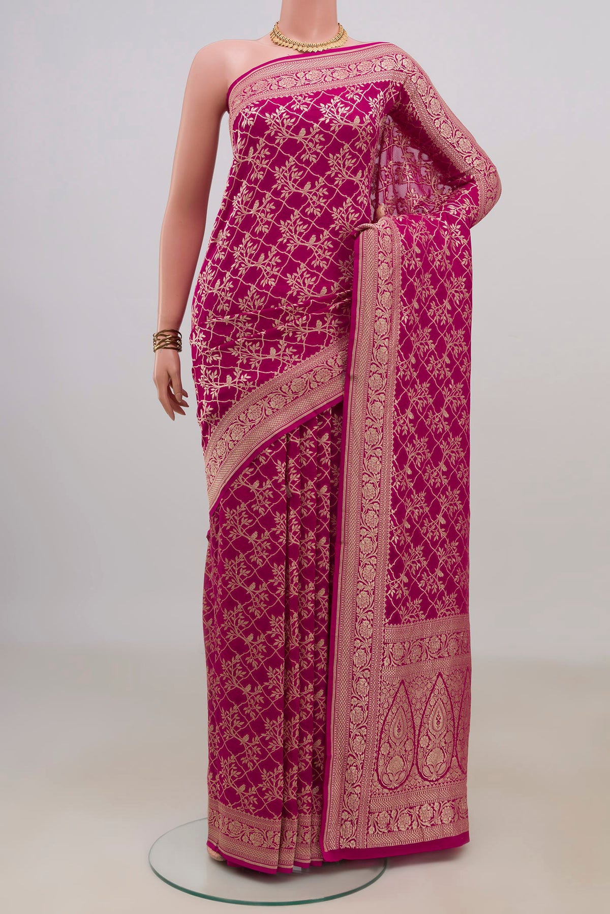 Pink Georgette Saree with Fancy on the body and Fancy Border.  displayed on a mannequin