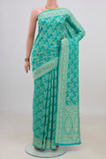 Turquoise Banarasi Georgette Saree with Zari Brocade on the body and Fancy Border.  displayed on a mannequin