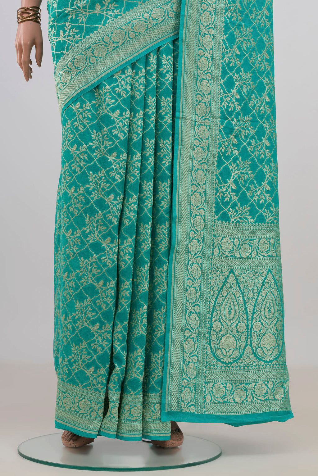 Pleats and pallu of Turquoise Banarasi Georgette Saree with Zari Brocade on the body and Fancy Border. 