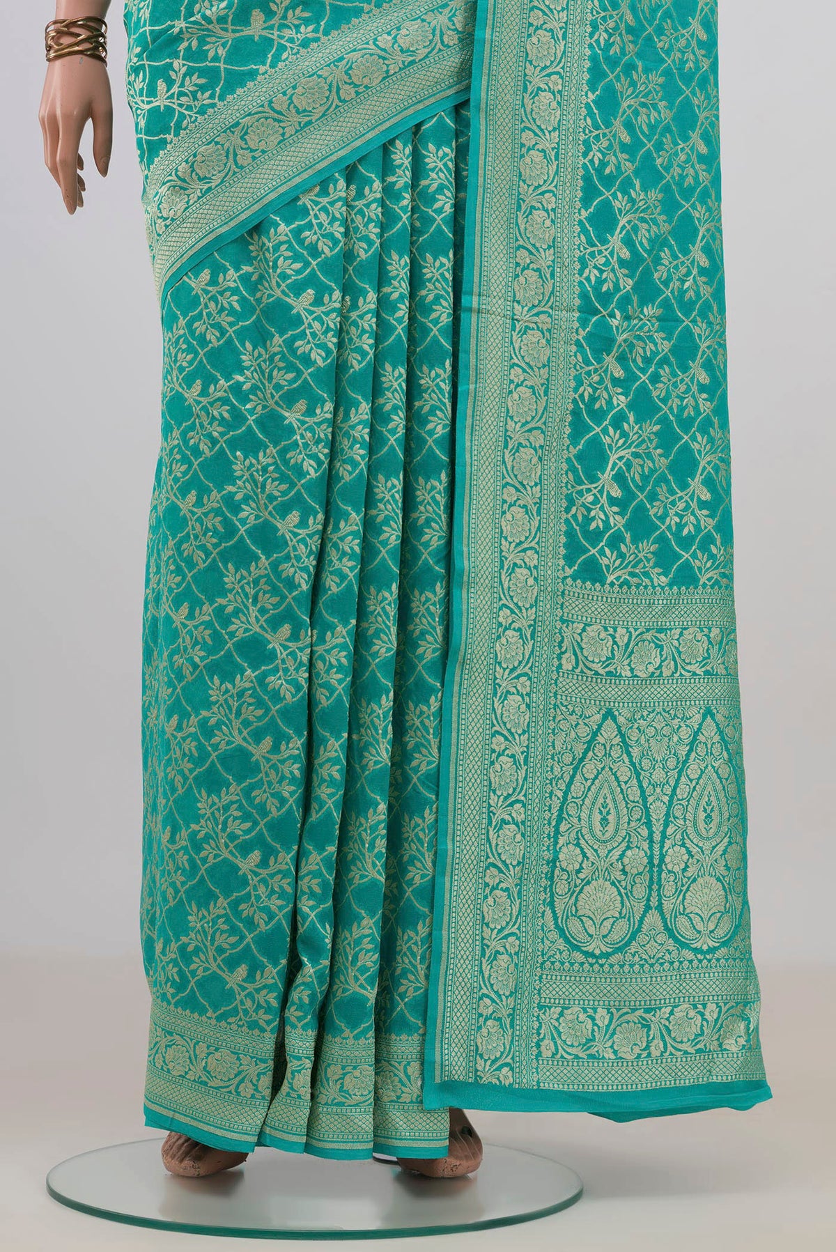 Pleats and pallu of Turquoise Banarasi Georgette Saree with Zari Brocade on the body and Fancy Border. 