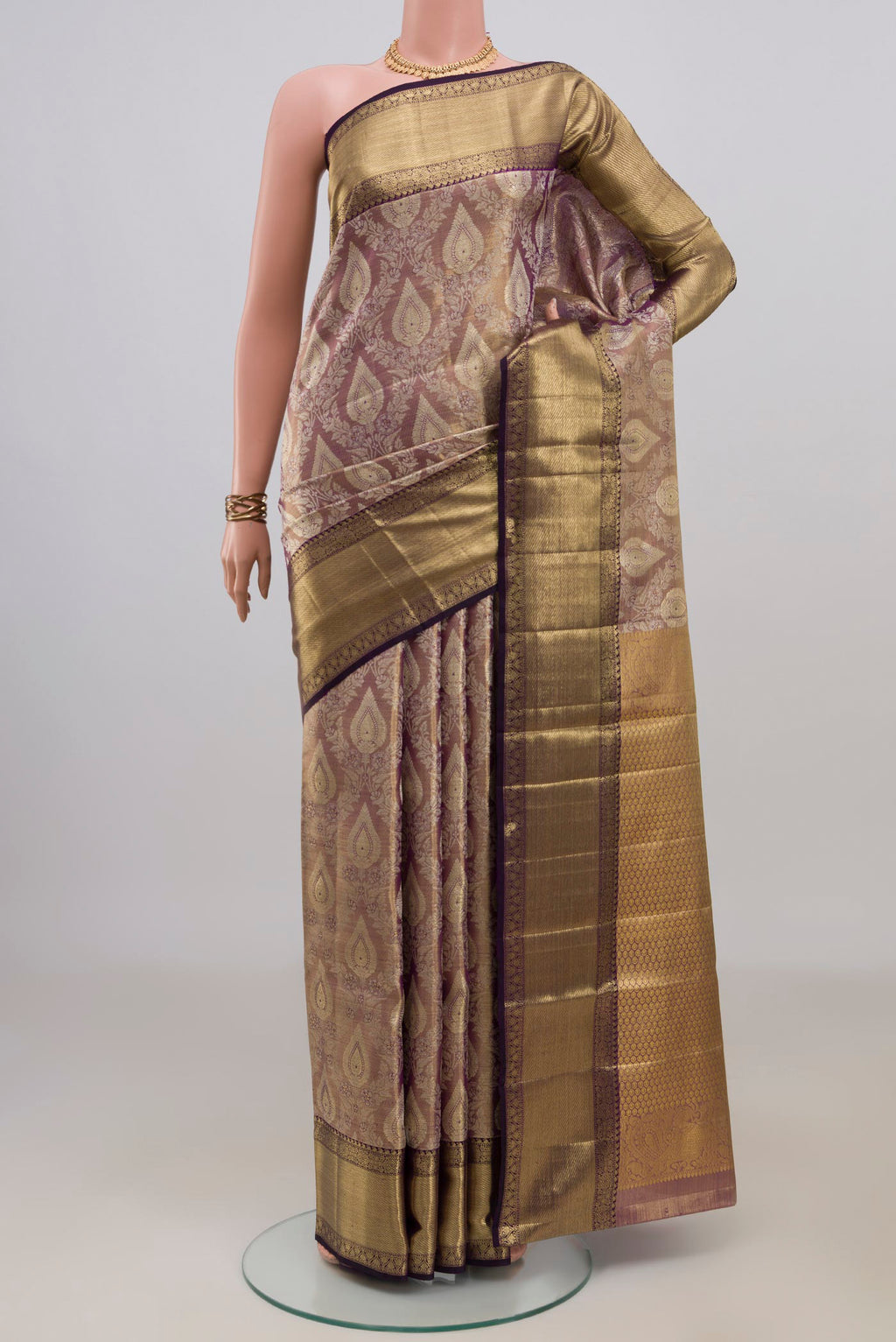 Gold with Purple Color Kanjivaram Tissue Saree with Zari Brocade on the body and Zari Border.  displayed on a mannequin