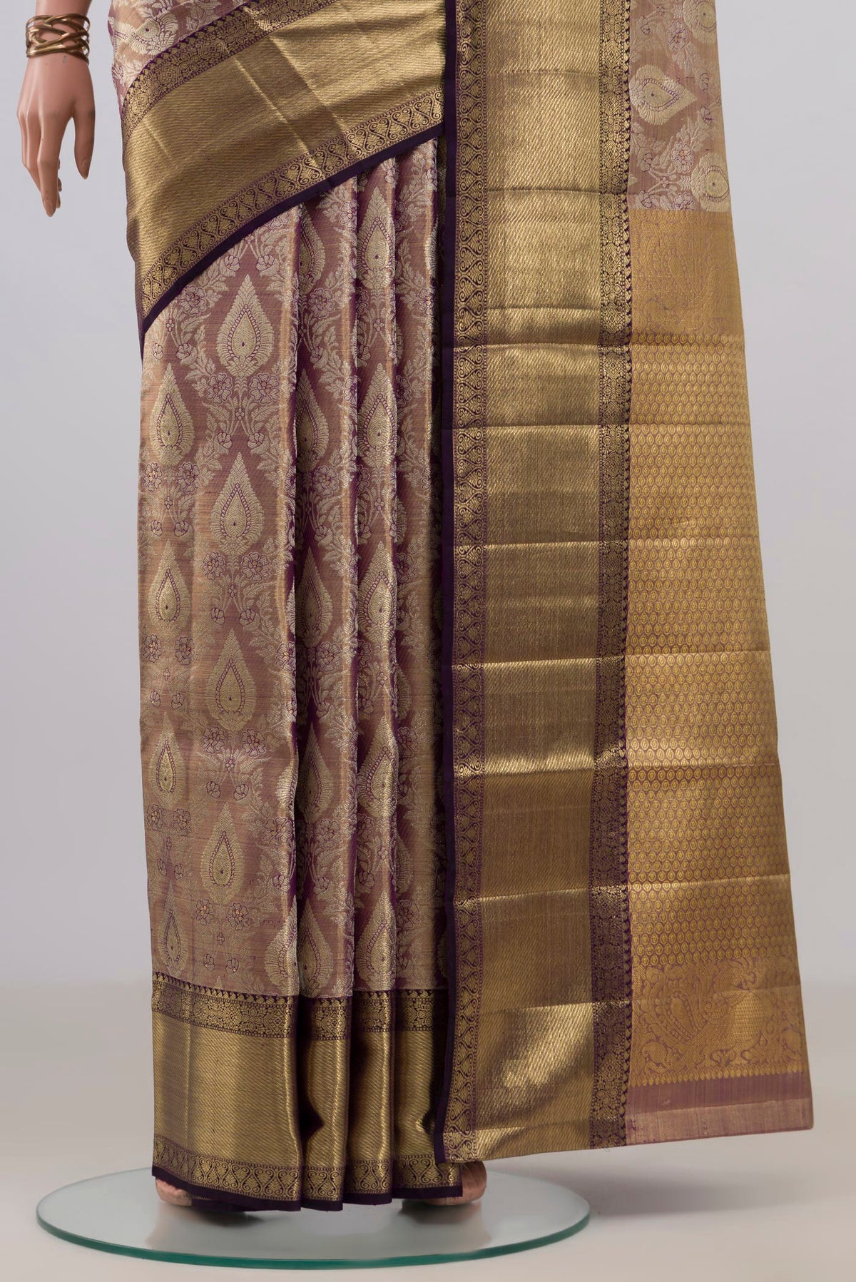 Pleats and pallu of Gold with Purple Color Kanjivaram Tissue Saree with Zari Brocade on the body and Zari Border. 