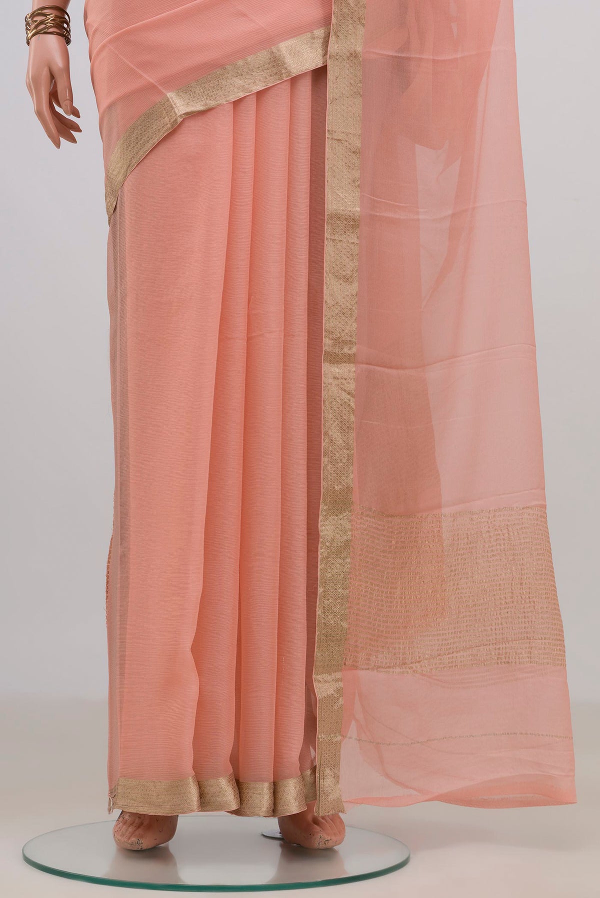 Pleats and pallu of Peach Mysore Chiffon Saree with Plain Body and Zari Border. 