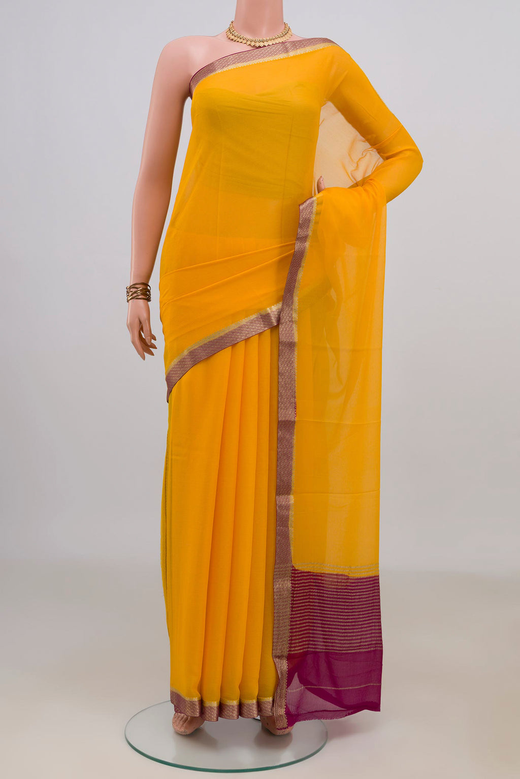 Yellow Mysore Chiffon Saree with Plain Body and Zari Border.  displayed on a mannequin