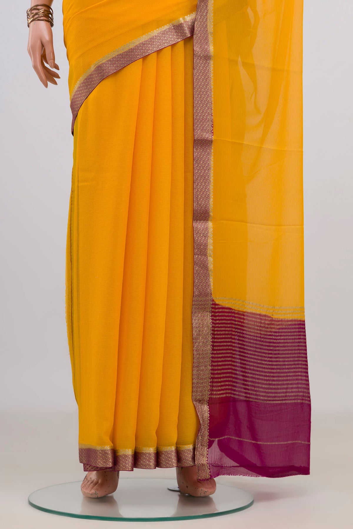 Pleats and pallu of Yellow Mysore Chiffon Saree with Plain Body and Zari Border. 