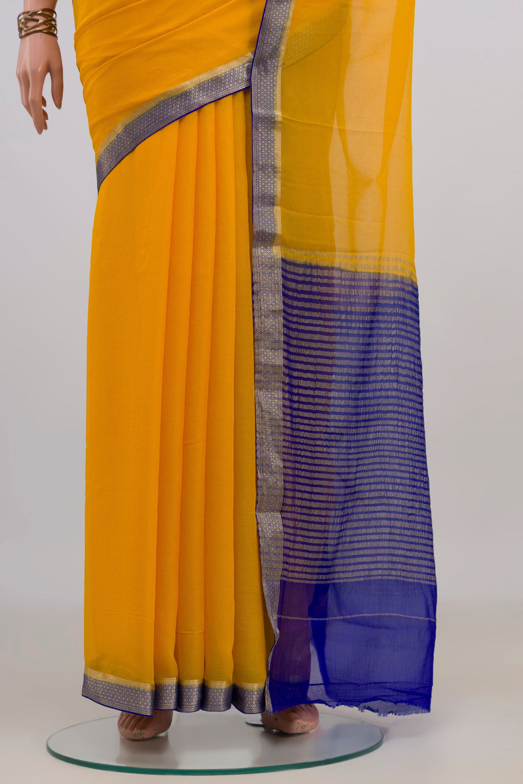 Pleats and pallu of Yellow Mysore Chiffon Saree with Plain Body and Zari Border. 