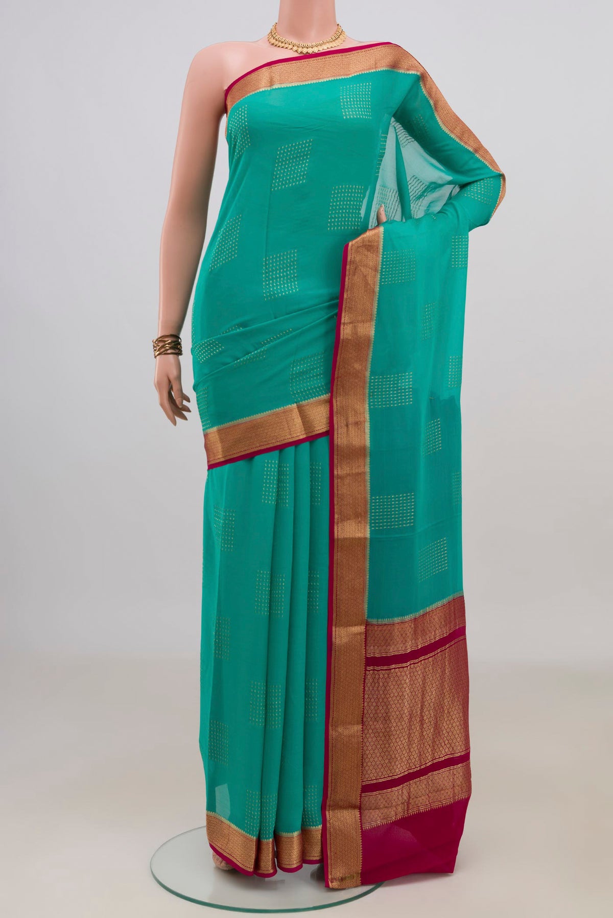 Turquoise Mysore Georgette Saree with Zari Butta on the body and Zari Border.  displayed on a mannequin