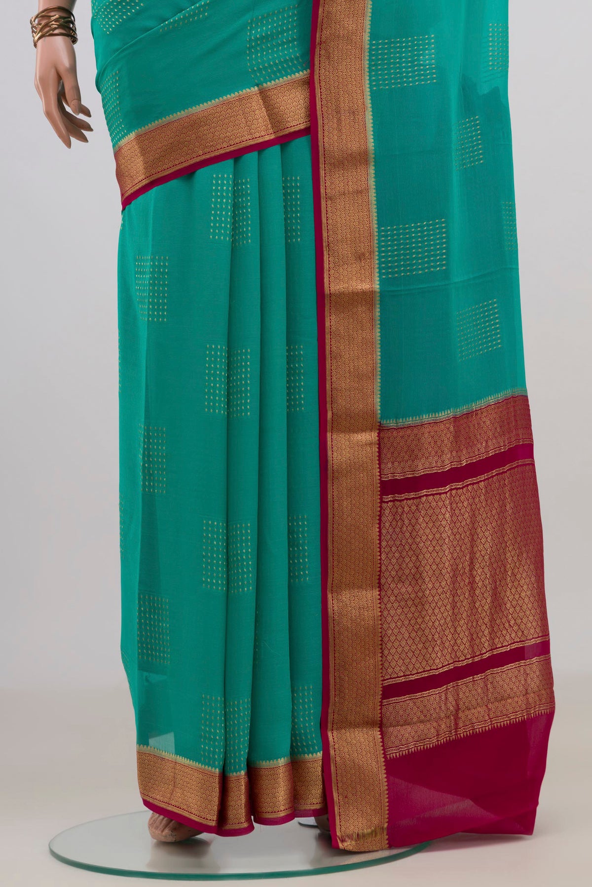 Pleats and pallu of Turquoise Mysore Georgette Saree with Zari Butta on the body and Zari Border. 