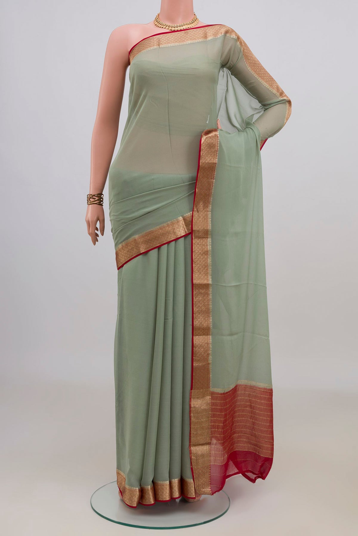 Pista Green Mysore Chiffon Saree with Plain Body and Zari Border.  displayed on a mannequin