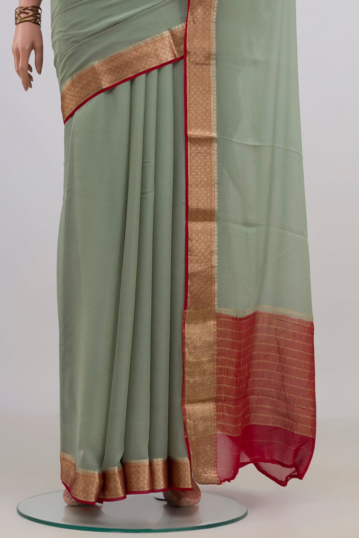 Pleats and pallu of Pista Green Mysore Chiffon Saree with Plain Body and Zari Border. 