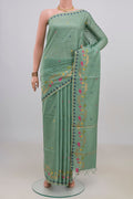 Light Green Tussar Saree with Thread Butta on the body and Thread Border.  displayed on a mannequin