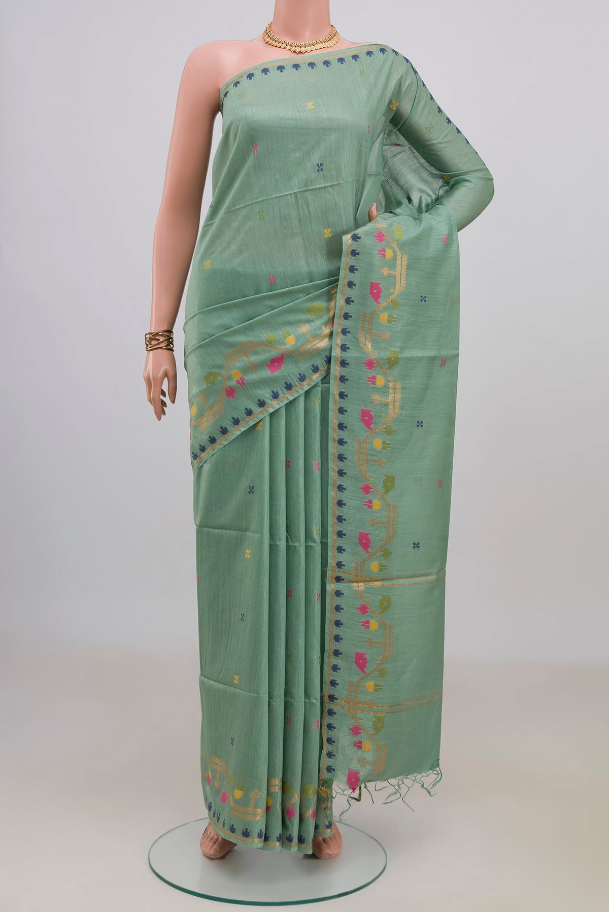 Light Green Tussar Saree with Thread Butta on the body and Thread Border.  displayed on a mannequin