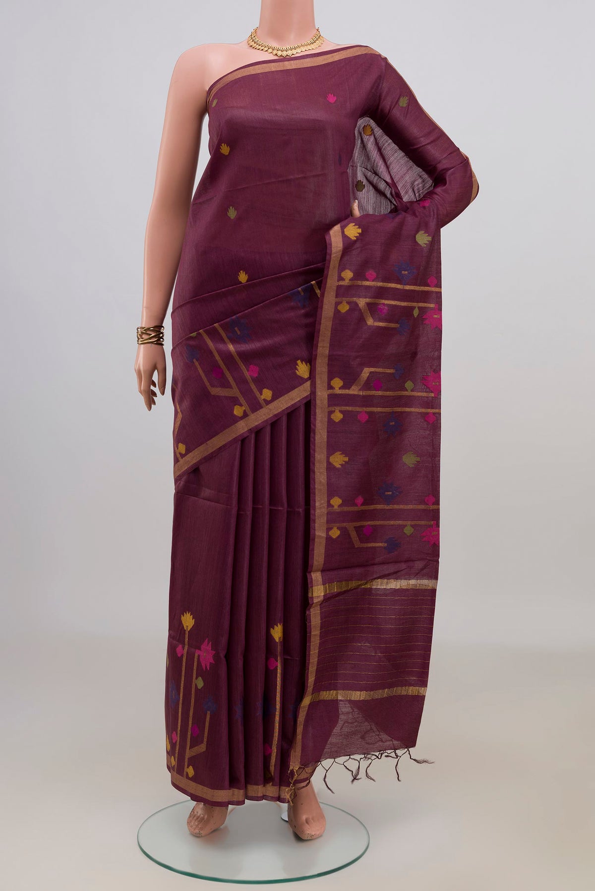 Brown Tussar Saree with Thread Butta on the body and Zari Border.  displayed on a mannequin