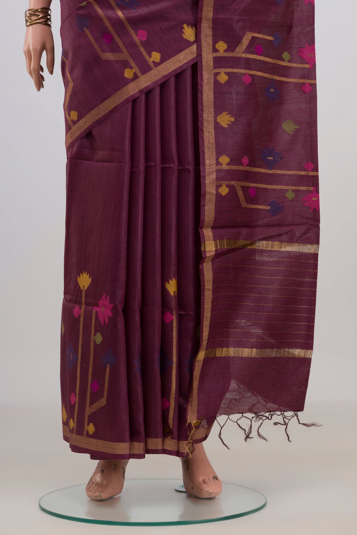 Pleats and pallu of Brown Tussar Saree with Thread Butta on the body and Zari Border. 