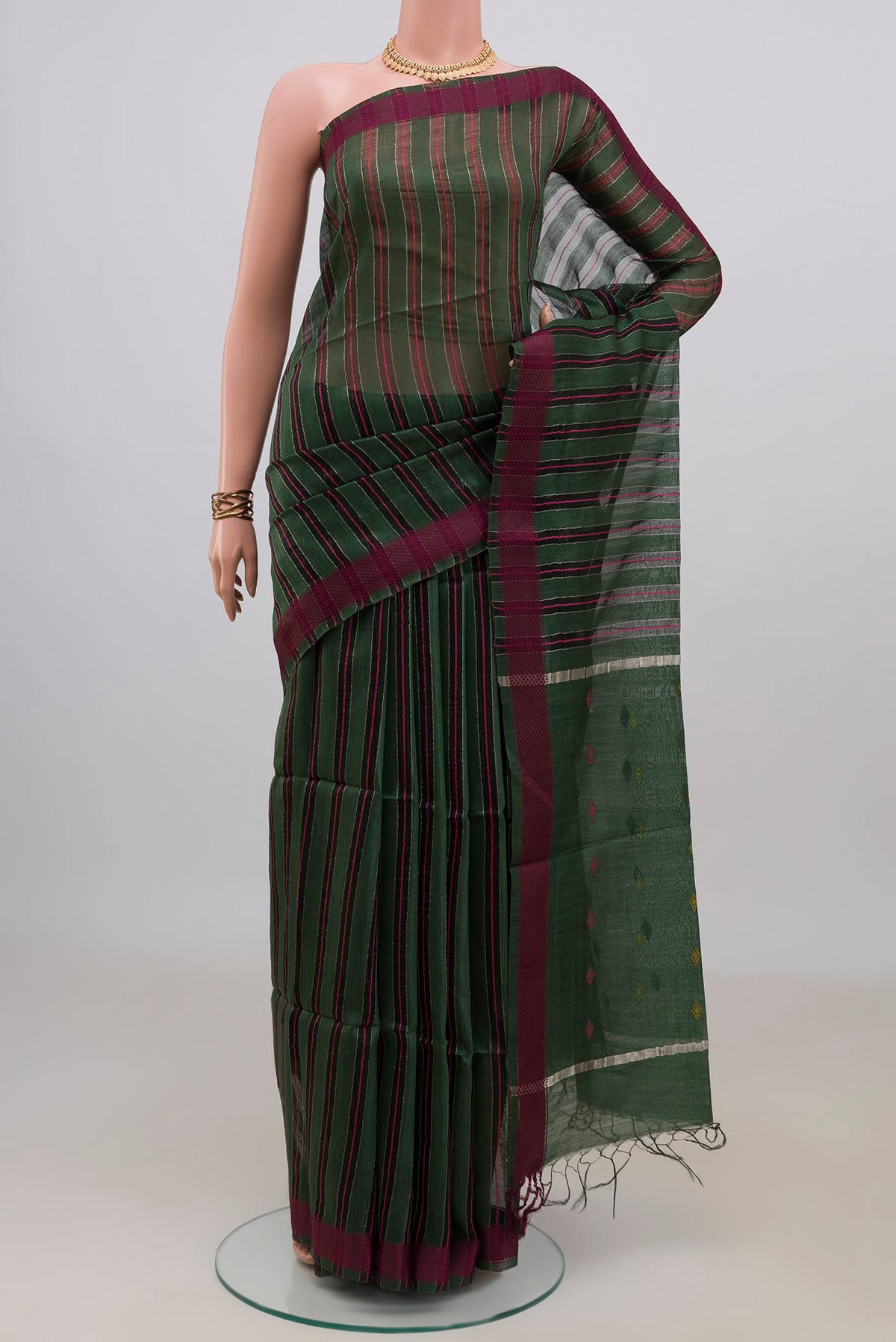 Pure Silk Green Tussar Saree with Thread Butta on the body and Thread Border.  displayed on a mannequin
