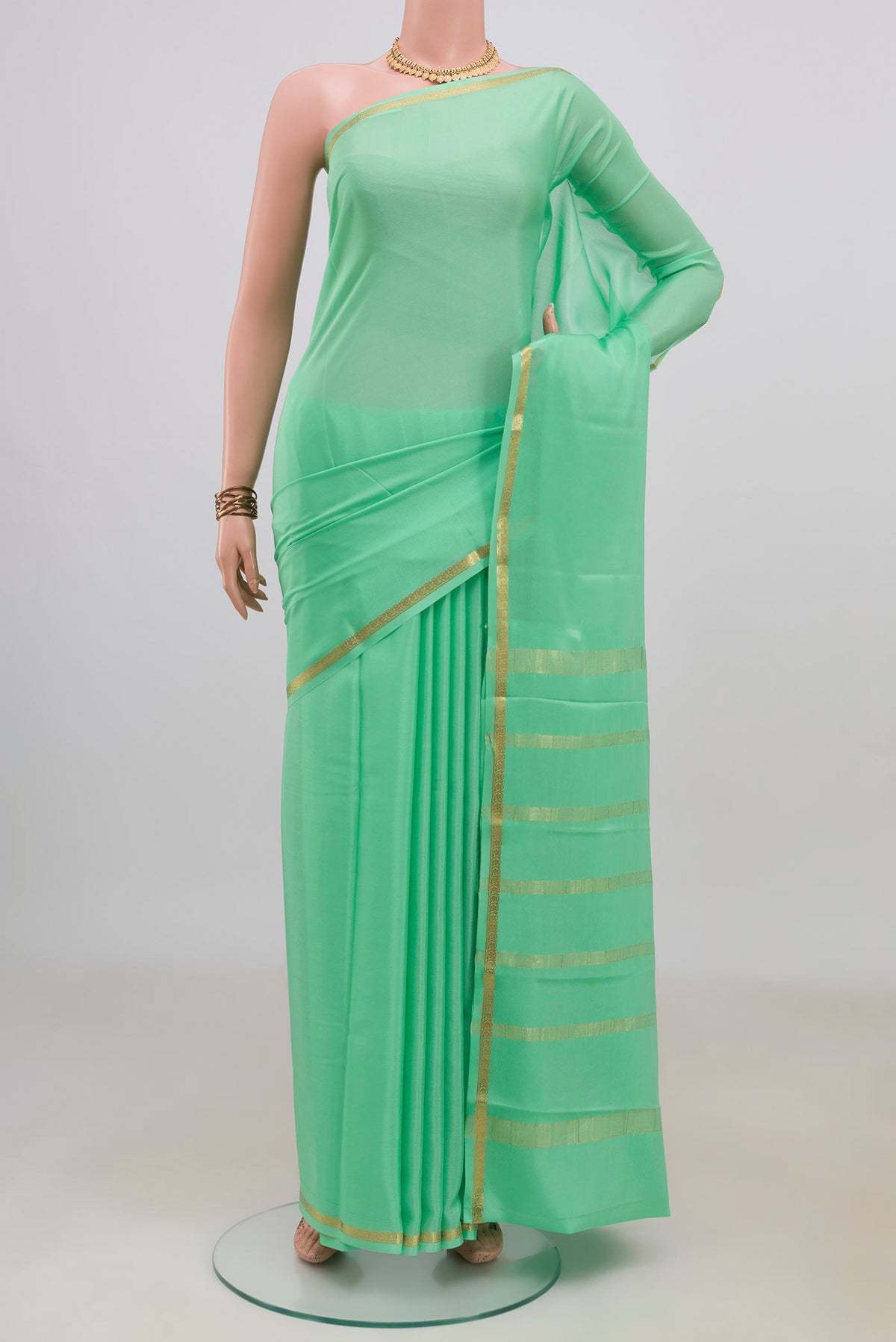 Mint Green Mysore Crepe Saree with Plain Body and Thin Zari Line.  displayed on a mannequin