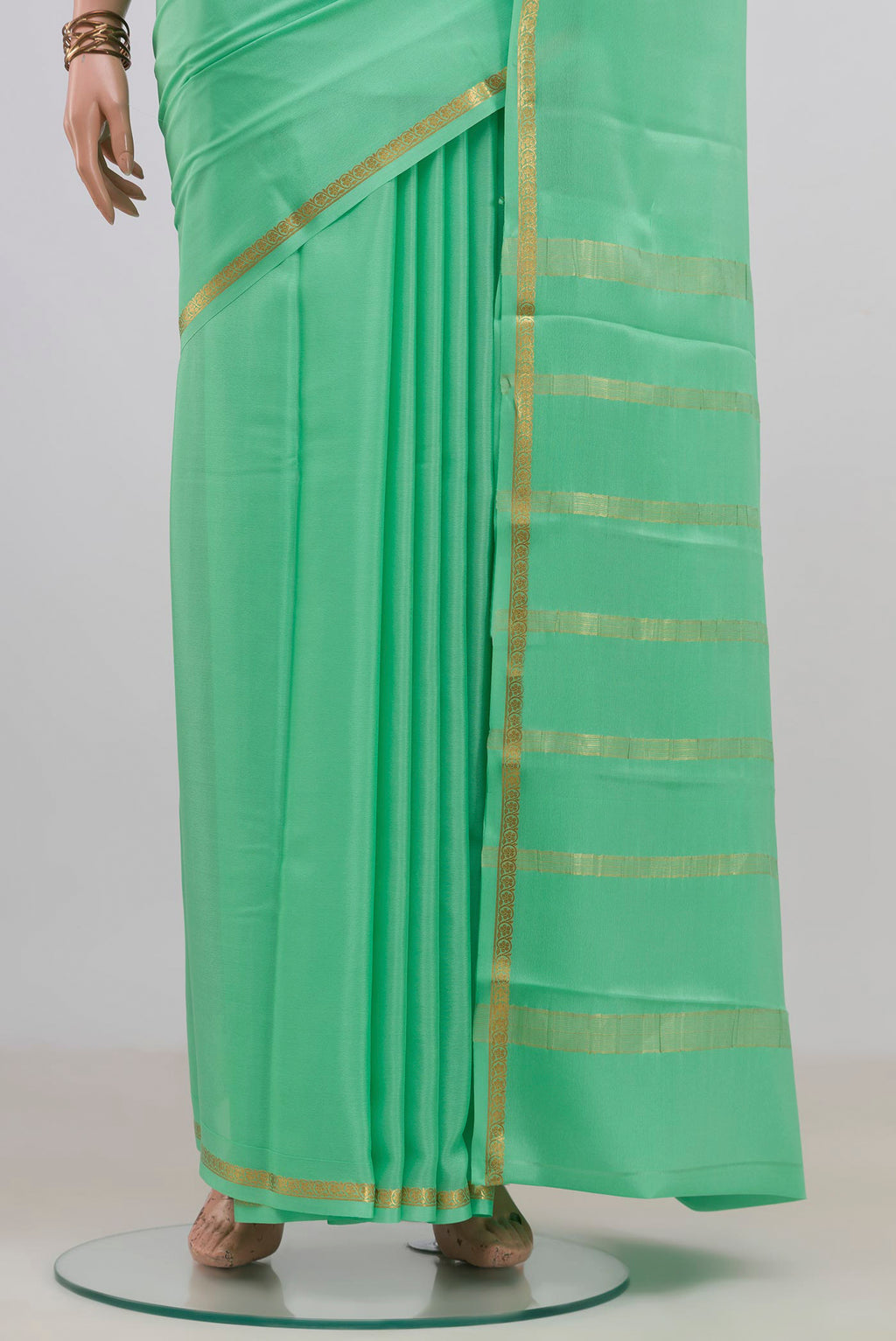 Pleats and pallu of Mint Green Mysore Crepe Saree with Plain Body and Thin Zari Line. 