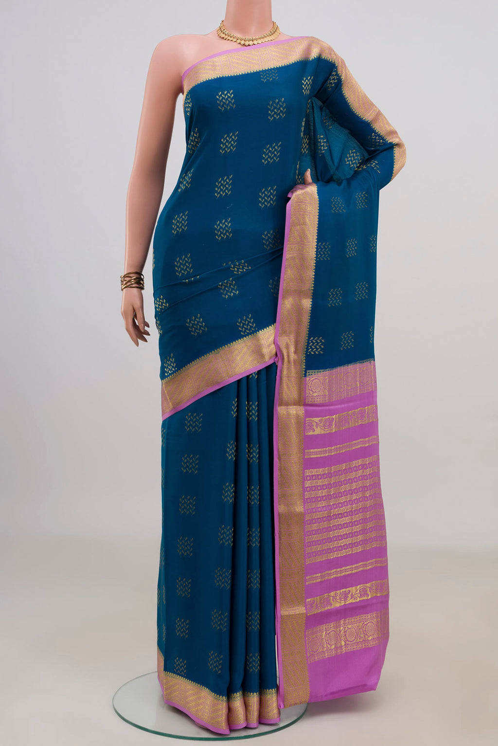 Blue Mysore Crepe Saree with Zari Butta on the body and Zari Border.  displayed on a mannequin