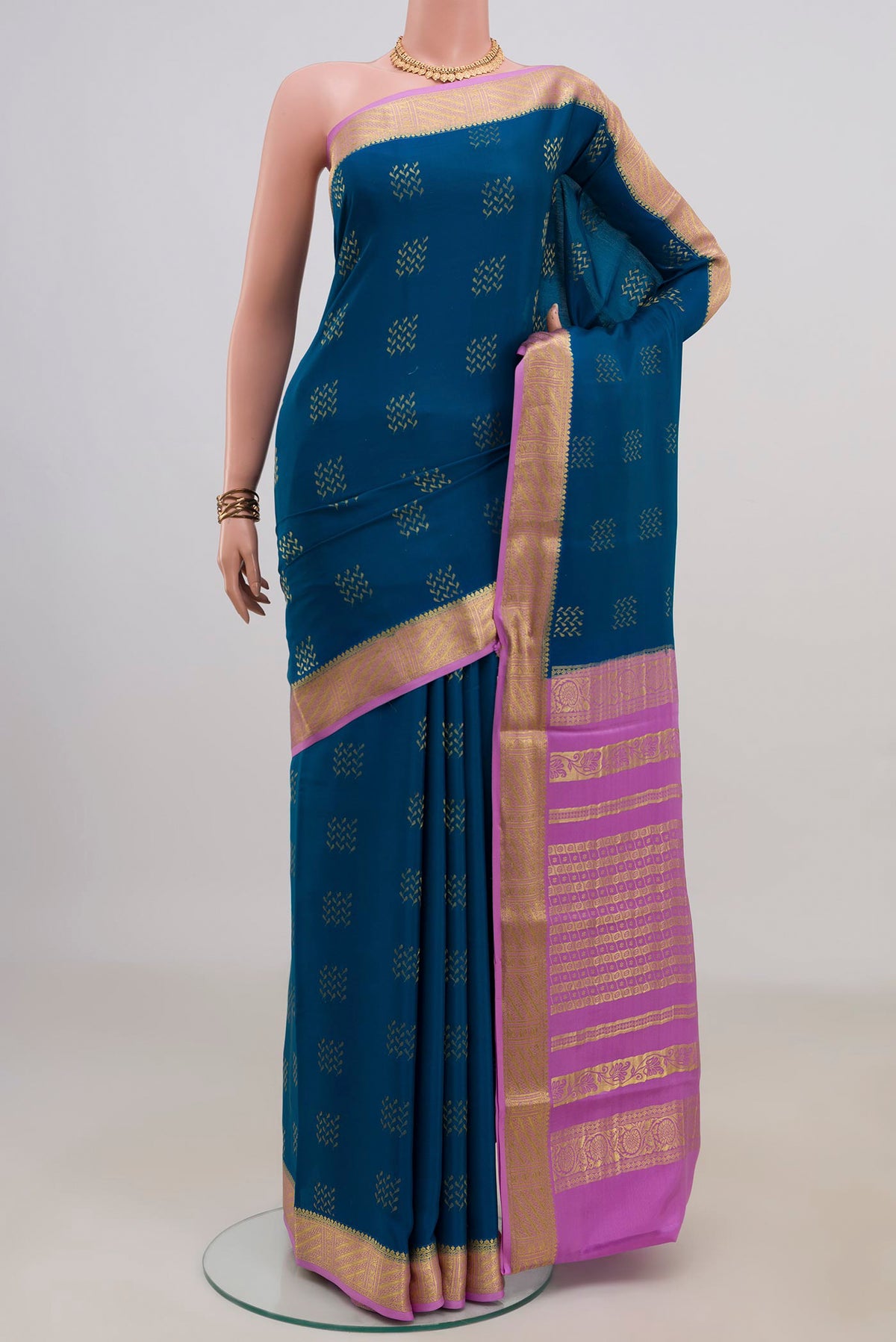 Blue Mysore Crepe Saree with Zari Butta on the body and Zari Border.  displayed on a mannequin