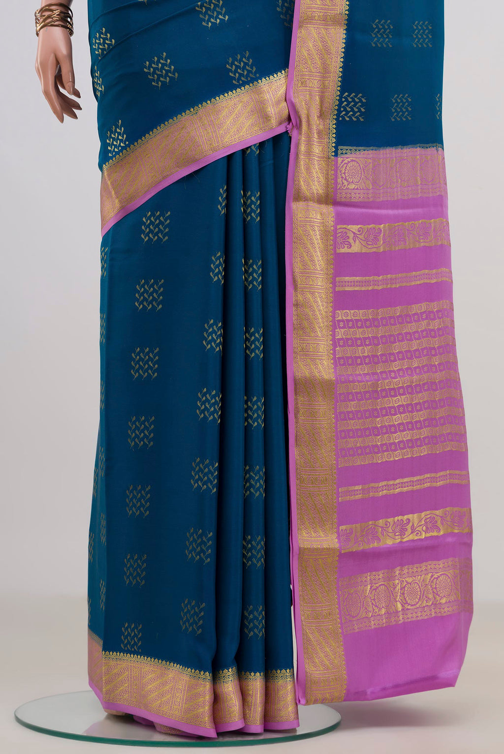 Pleats and pallu of Blue Mysore Crepe Saree with Zari Butta on the body and Zari Border. 