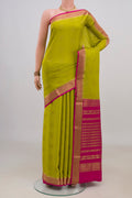 Green Mysore Crepe Saree with Zari Butta on the body and Zari Border.  displayed on a mannequin