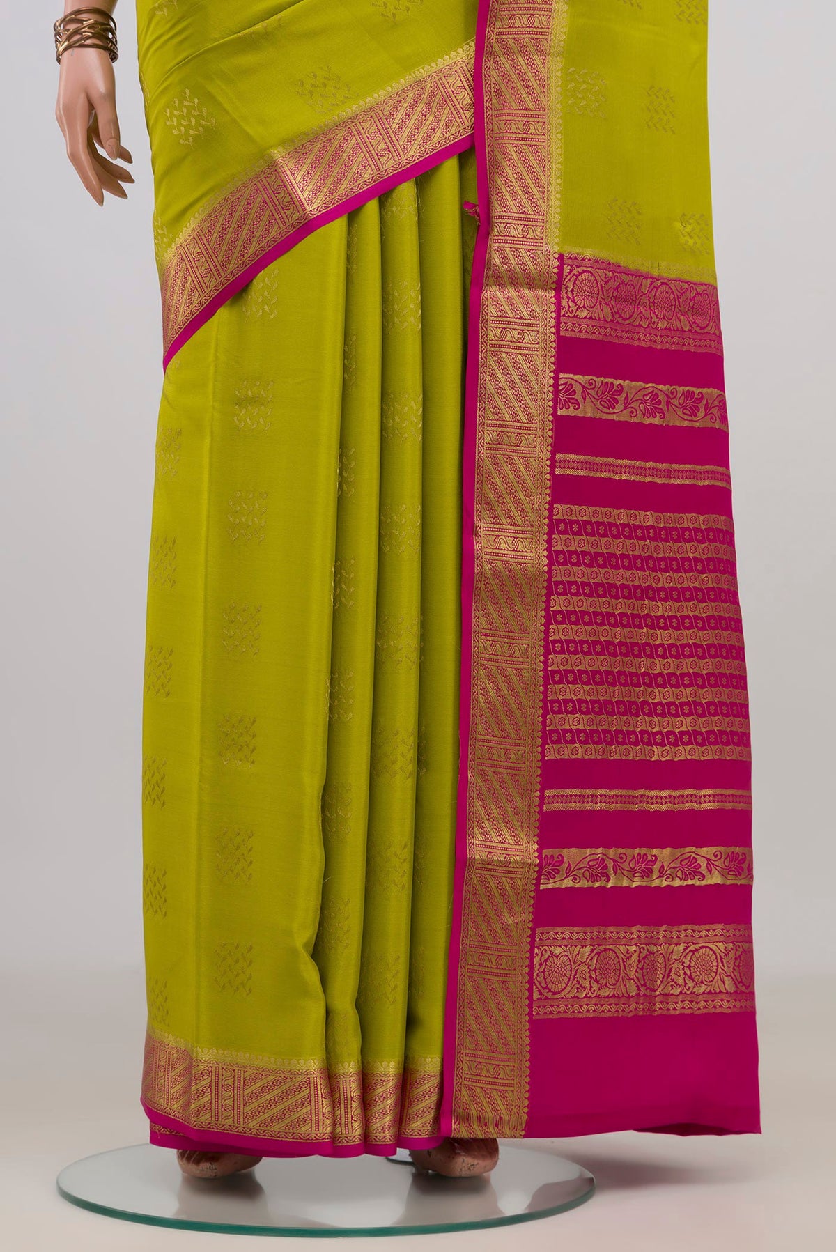 Pleats and pallu of Green Mysore Crepe Saree with Zari Butta on the body and Zari Border. 