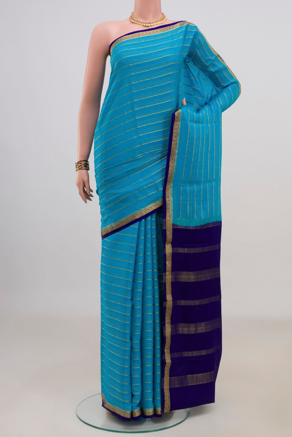 Light Blue Mysore Crepe Saree with Stripes on the body and Zari Border.  displayed on a mannequin