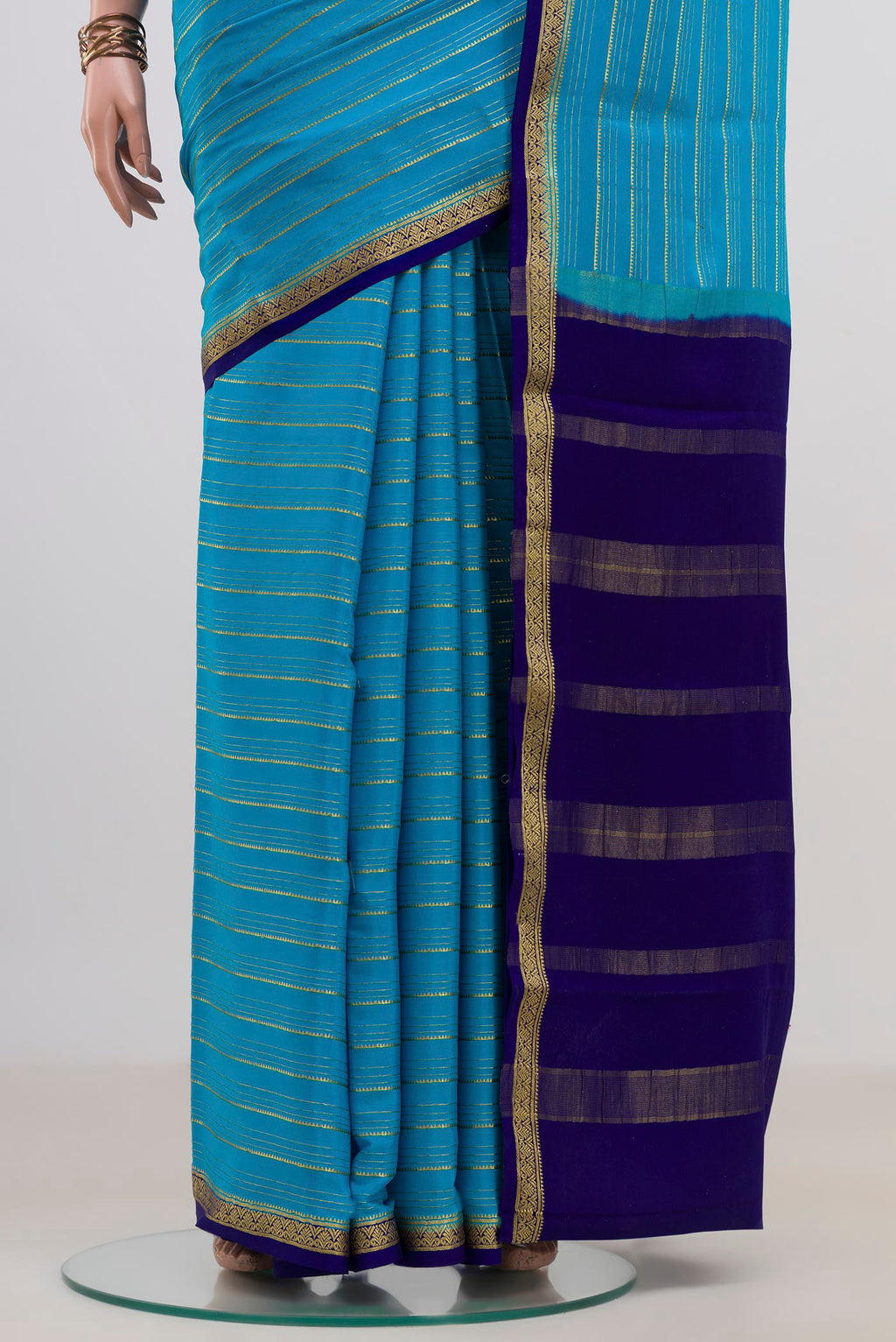Pleats and pallu of Light Blue Mysore Crepe Saree with Stripes on the body and Zari Border. 