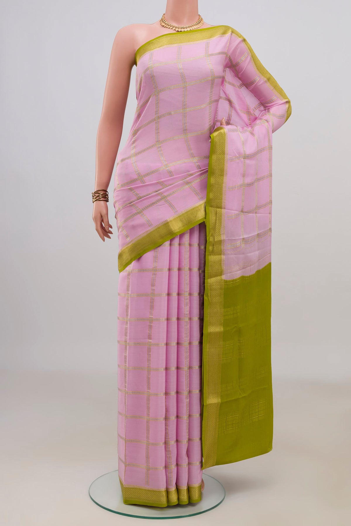 Pink Crepe Saree with Checked design on the body and Zari Border.  displayed on a mannequin