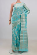 Pure Silk Light Blue Banarasi Raw Saree with Zari And Thread Butta on the body and Fancy Border.  displayed on a mannequin