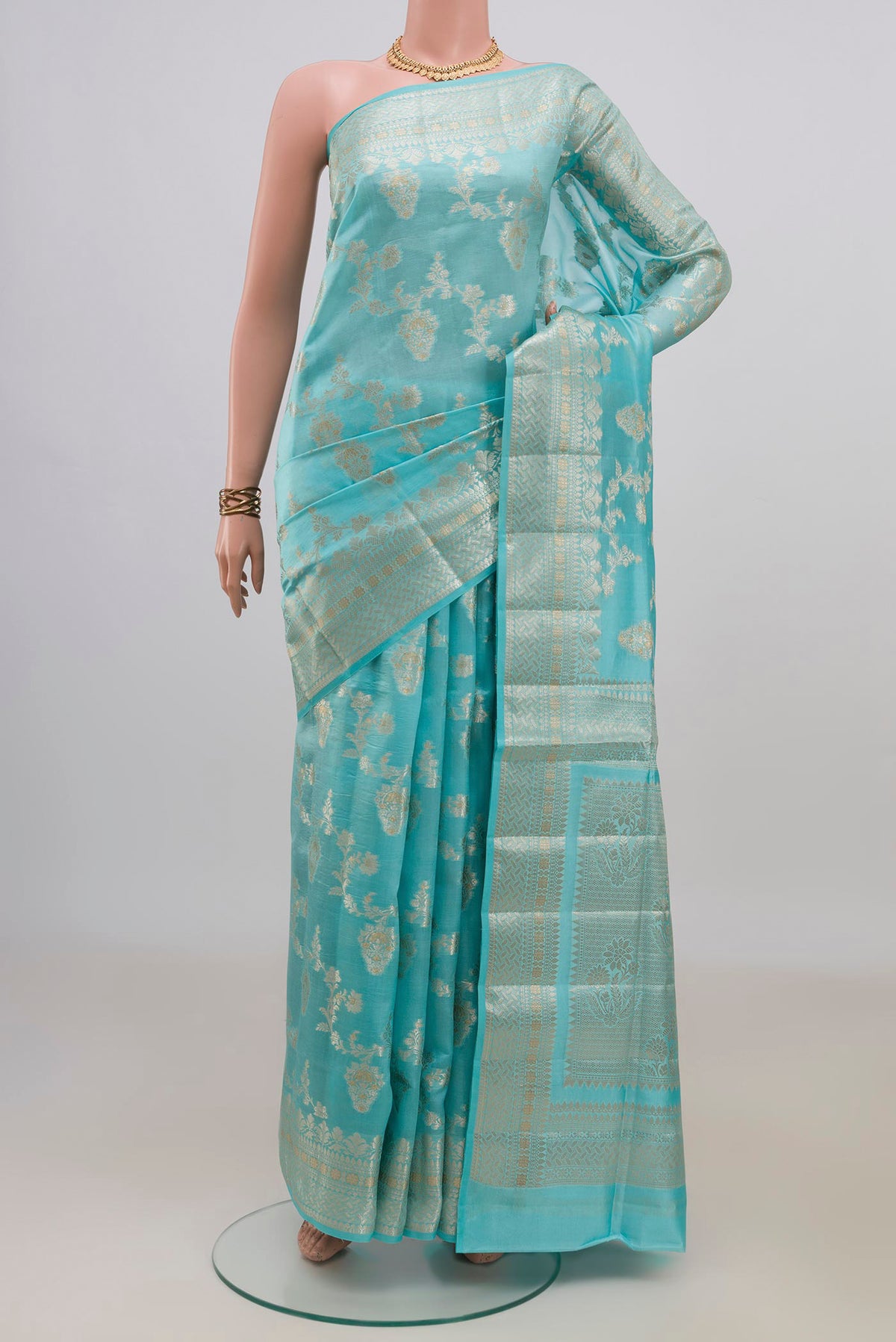Pure Silk Light Blue Banarasi Raw Saree with Zari And Thread Butta on the body and Fancy Border.  displayed on a mannequin