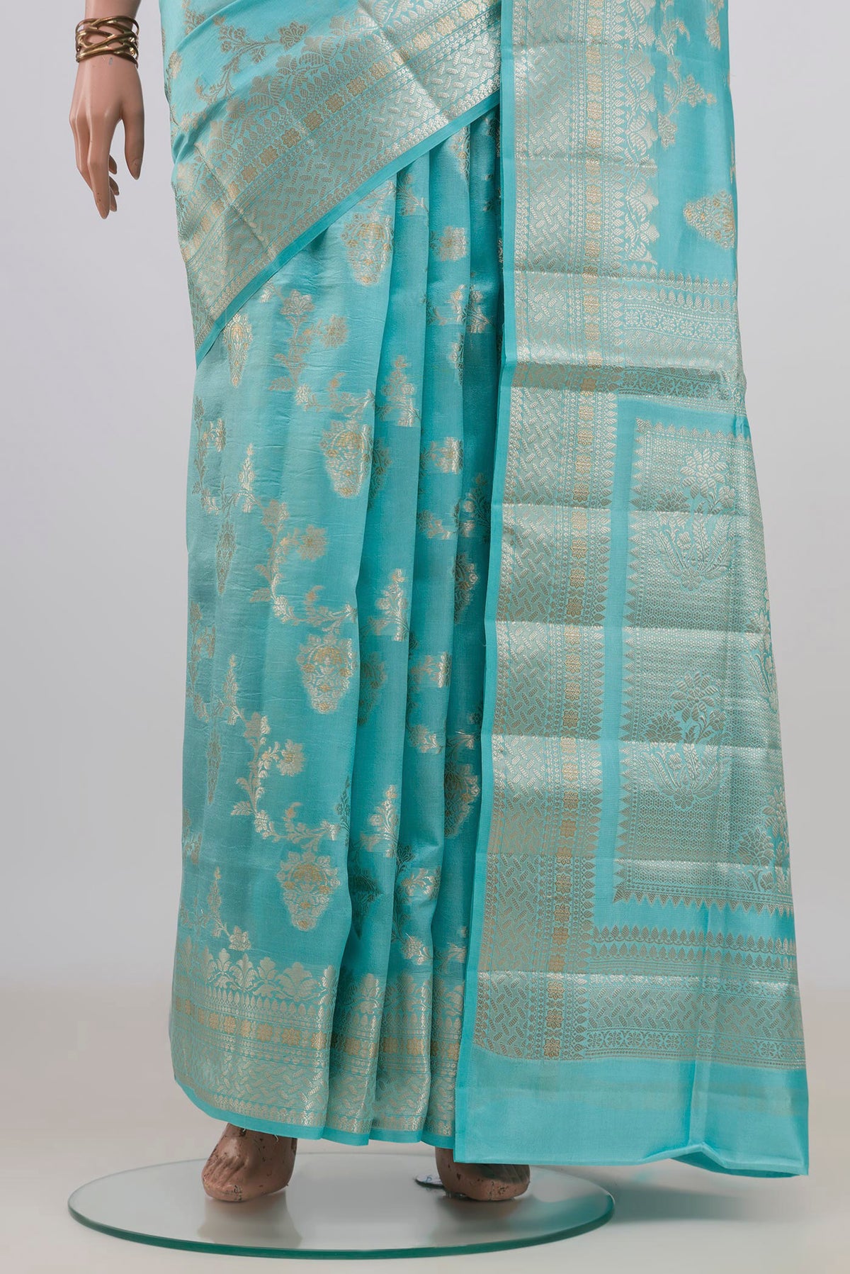 Pleats and pallu of Pure Silk Light Blue Banarasi Raw Saree with Zari And Thread Butta on the body and Fancy Border. 