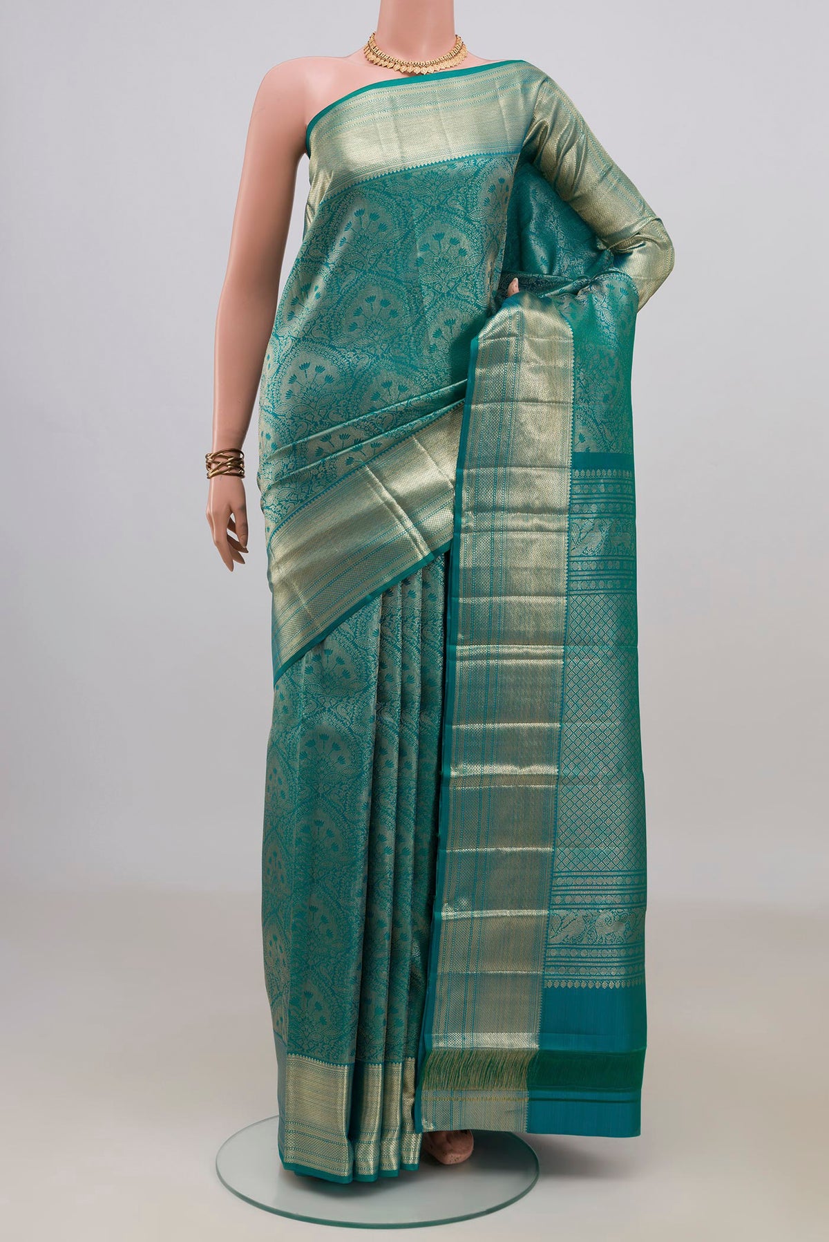 Pure Silk Peacock Blue Dual Tone Kanchipuram Saree with Zari Brocade on the body and Zari Border.  displayed on a mannequin
