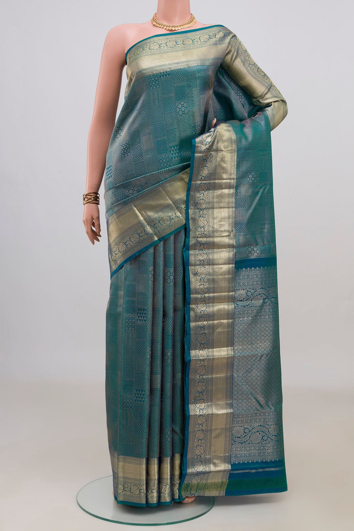 Pure Silk Peacock Blue Kanjivaram Saree with Zari Brocade on the body and Zari Border.  displayed on a mannequin