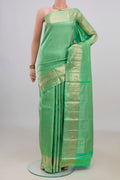 Pure Silk Green Kanjivaram Saree with Zari Brocade on the body and Zari Border.  displayed on a mannequin