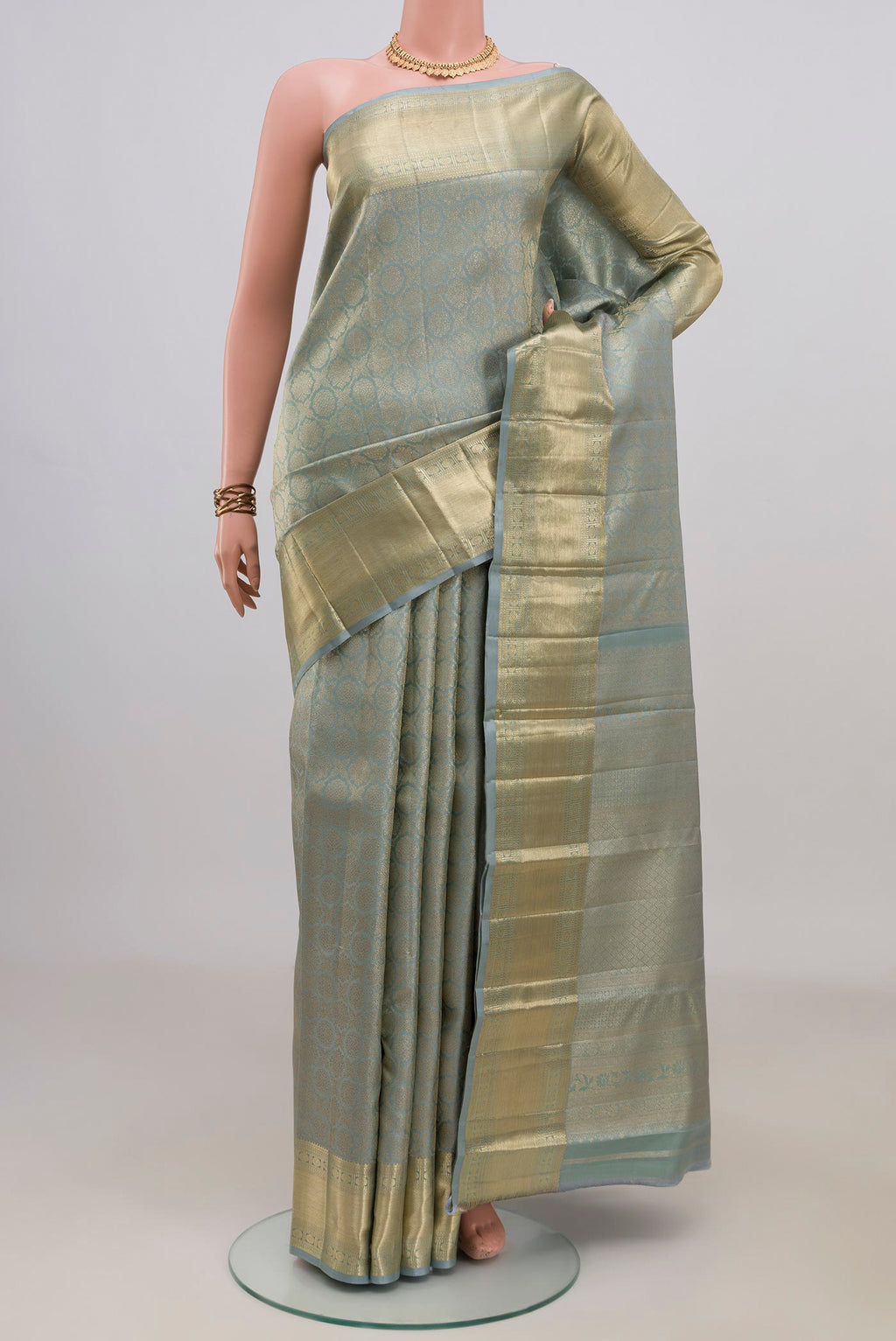Pure Silk Grey Kanjivaram Saree with Zari Brocade on the body and Zari Border.  displayed on a mannequin