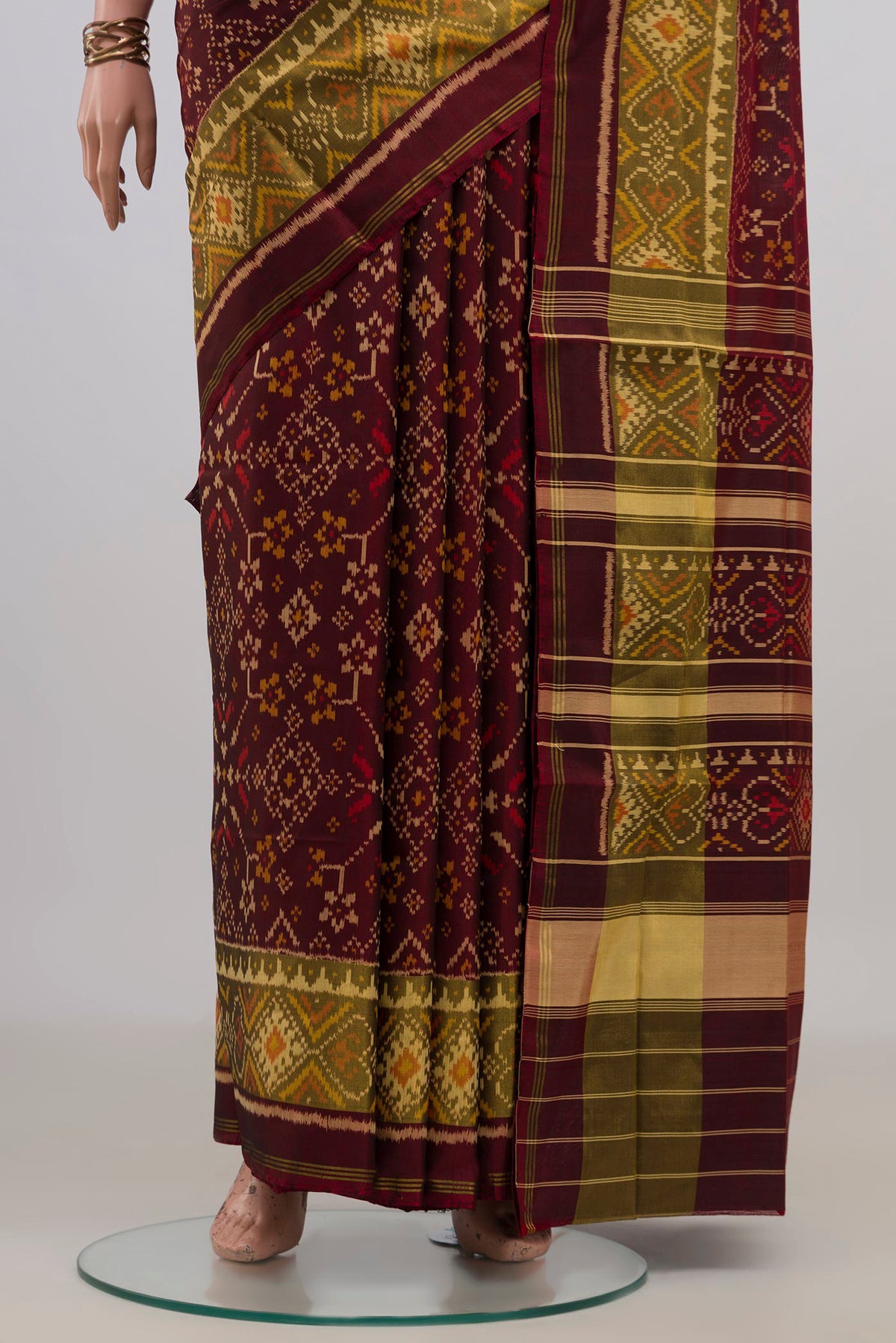 Pleats and pallu of Pure Silk Coffee Brown Rajkot Patola Saree with Ikat design on the body and Ikat Border. 