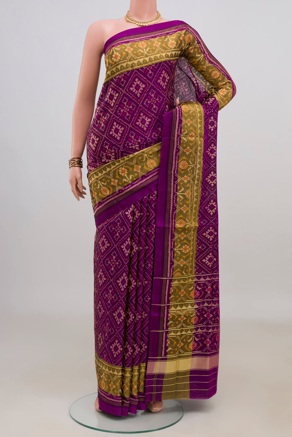 Pure Silk Purple Rajkot Patola Saree with Ikat design on the body and Thin Zari Line.  displayed on a mannequin