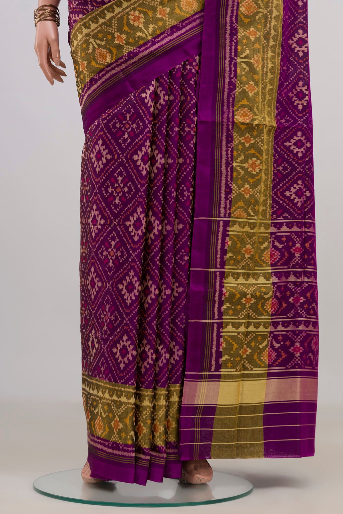 Pleats and pallu of Pure Silk Purple Rajkot Patola Saree with Ikat design on the body and Thin Zari Line. 