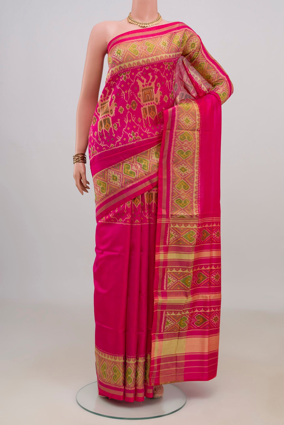 Pure Silk Pink Rajkot Patola Saree with Pure Ikat on the body and Ikat Border.  displayed on a mannequin