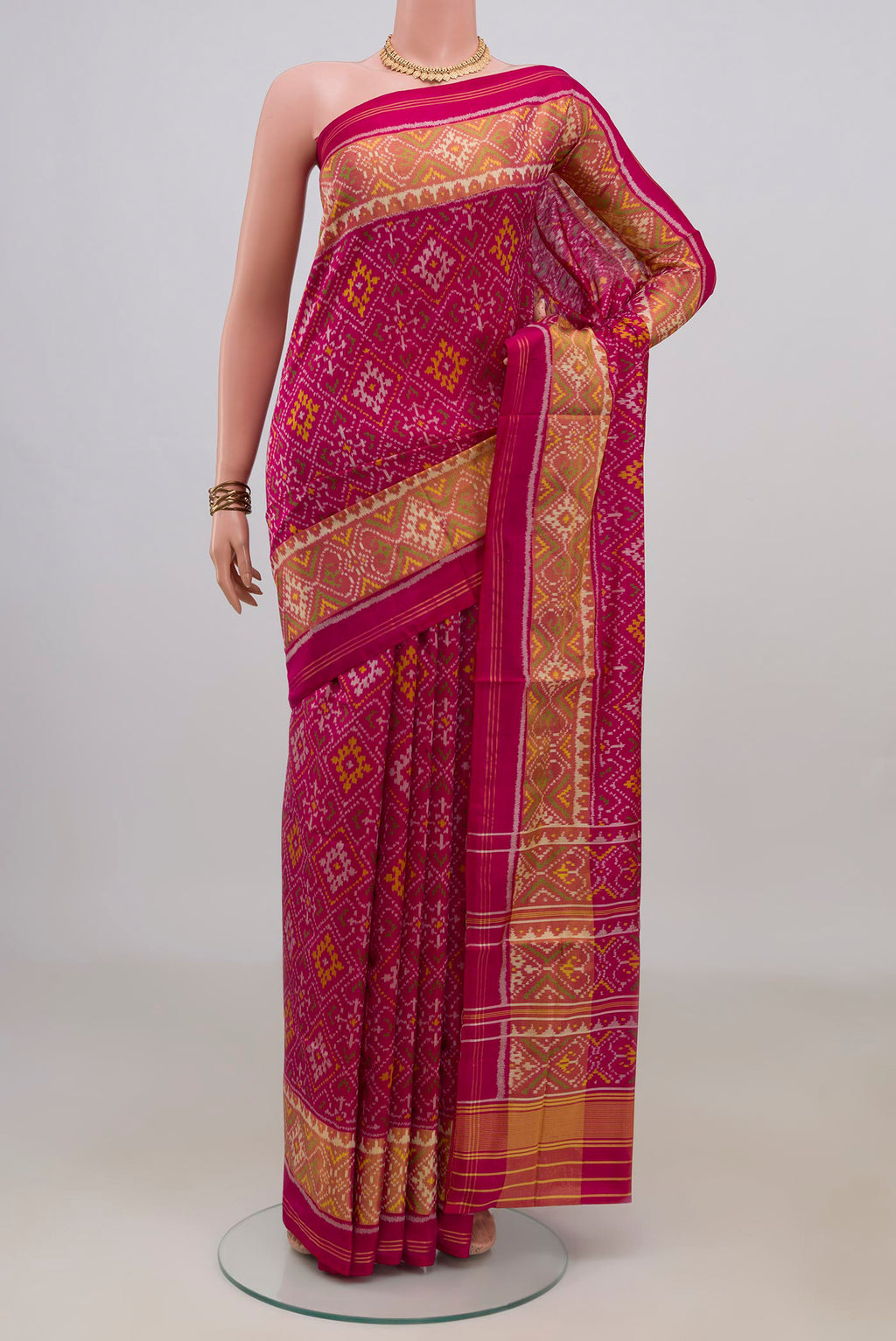 Pure Silk Dark Pink Rajkot Patola Saree with Pure Ikat on the body and Ikat Border.  displayed on a mannequin