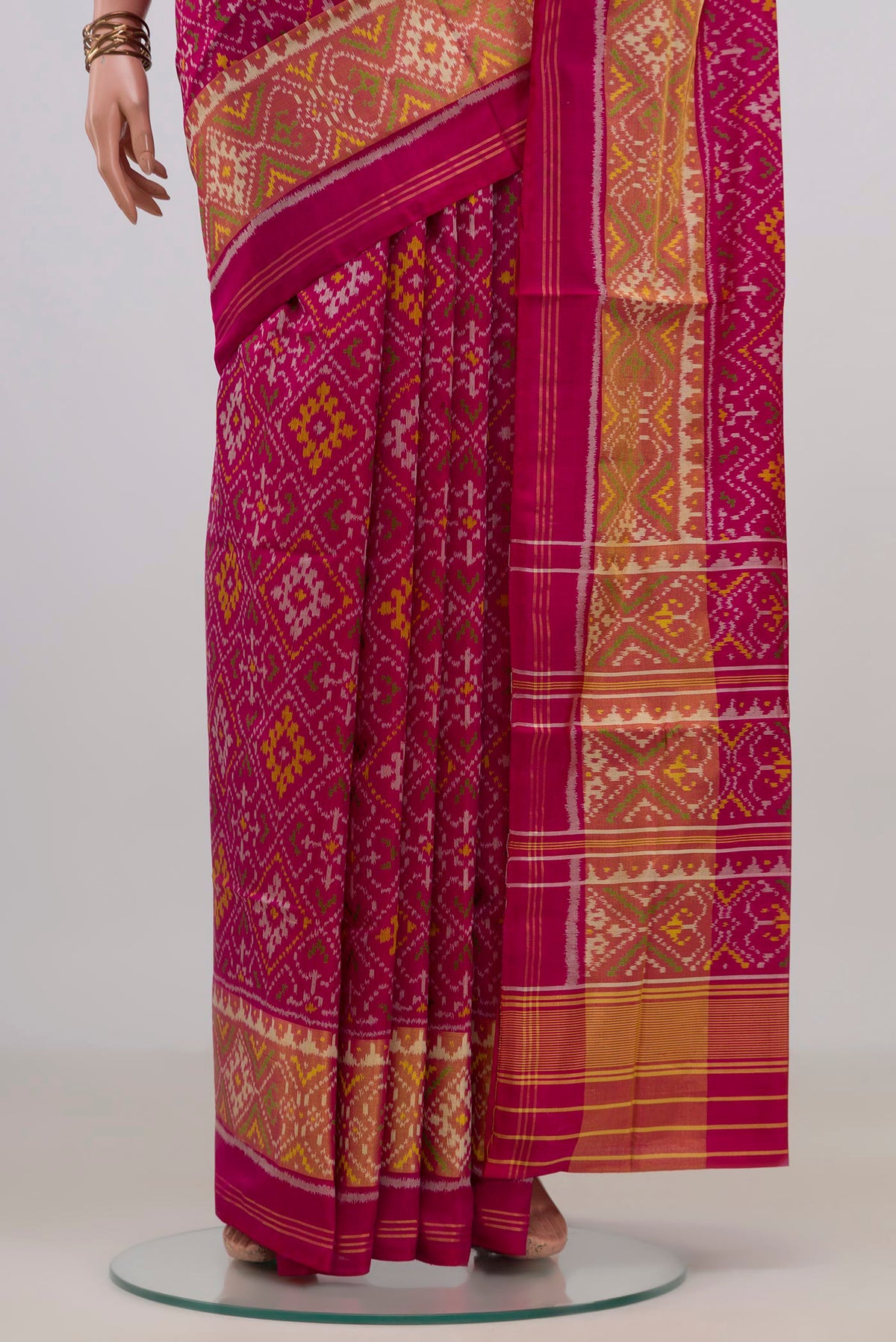 Pleats and pallu of Pure Silk Dark Pink Rajkot Patola Saree with Pure Ikat on the body and Ikat Border. 
