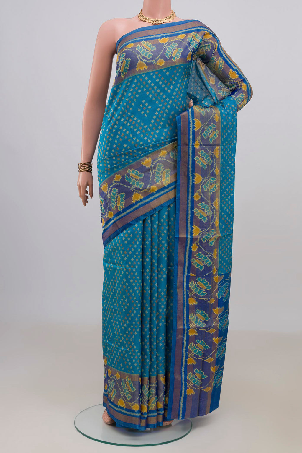 Pure Silk Blue Rajkot Patola Saree with Pure Ikat on the body and Ikat Border.  displayed on a mannequin