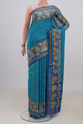 Pure Silk Blue Rajkot Patola Saree with Pure Ikat on the body and Ikat Border.  displayed on a mannequin